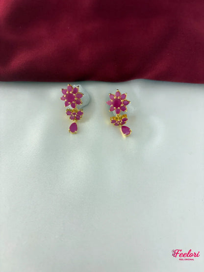 FeelOri Gold Plated Ruby Floral Motif Earrings - Close-up view of the intricate floral cluster earrings with a dangling ruby-hued tear drop.