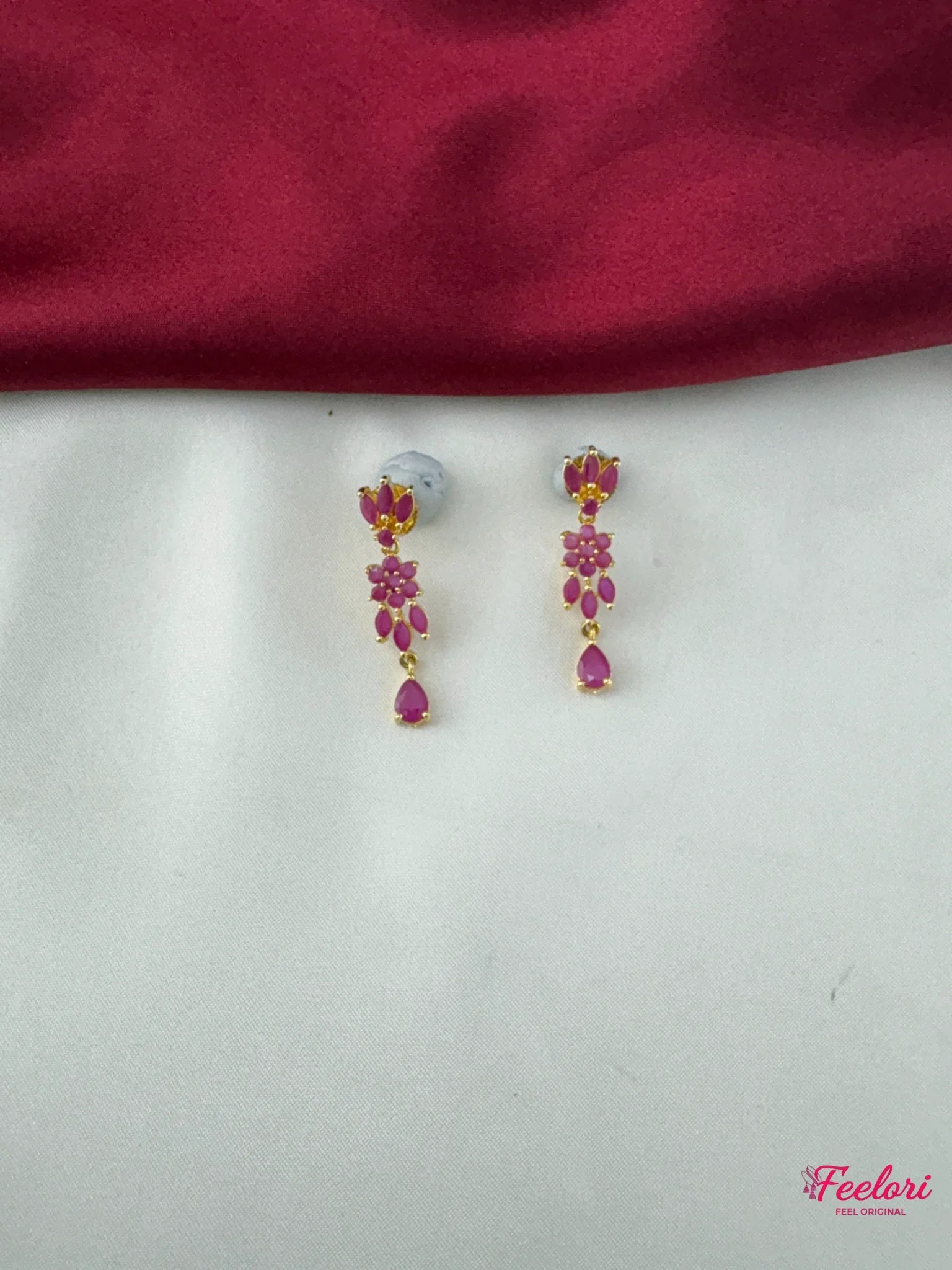 FeelOri Gold Plated Ruby Floral Earrings - Close-up of the delicate push-back earrings with multiple ruby-hued stone florets.