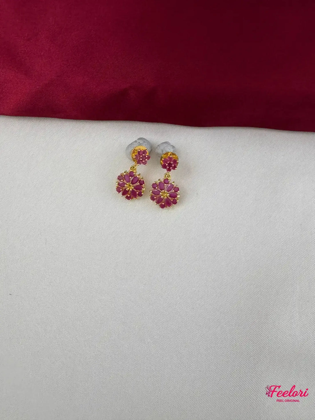 FeelOri Gold Plated Ruby Floral Earrings - Close-up view highlighting the detailed twin floral motifs and push-back closure.
