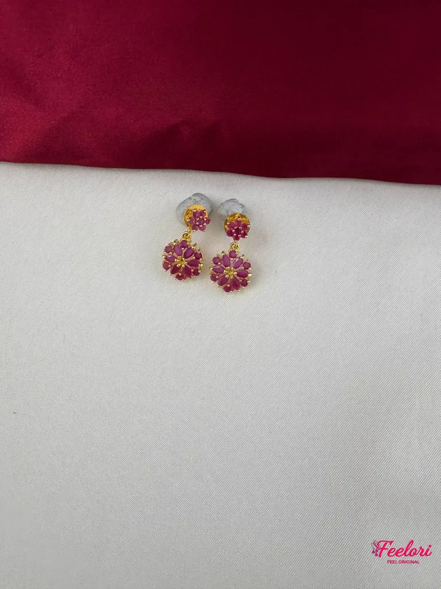 FeelOri Gold Plated Ruby Floral Earrings - Close-up view highlighting the detailed twin floral motifs and push-back closure.