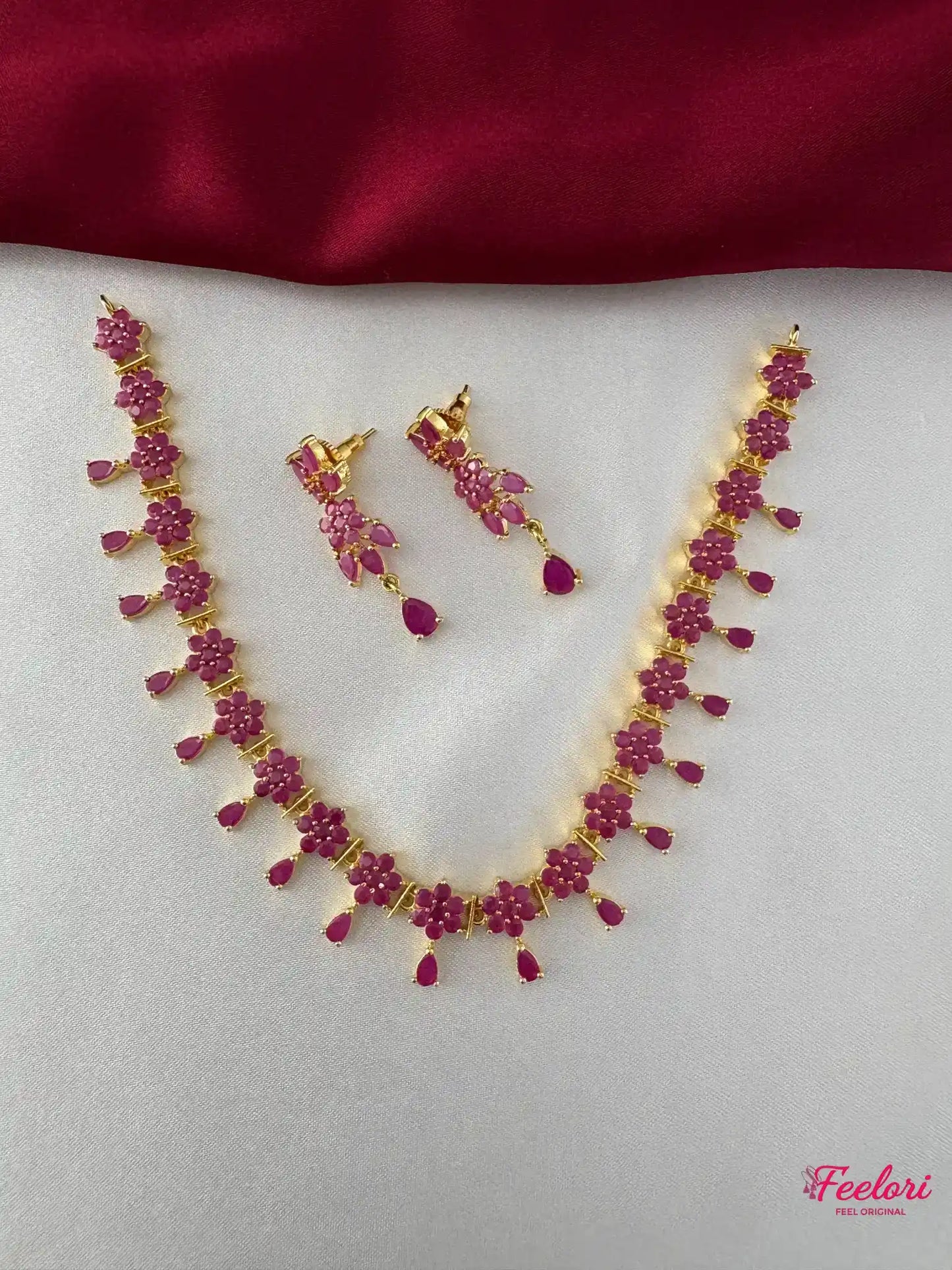 FeelOri Gold Plated Ruby Flower Necklace Set - Front view showcasing the complete set with interconnected floral ruby stones and matching earrings.