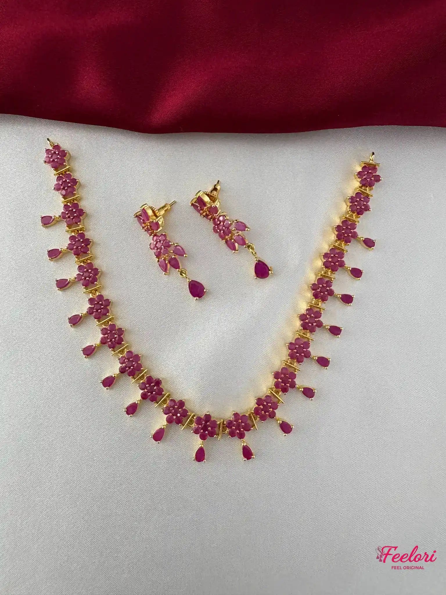 FeelOri Gold Plated Ruby Flower Necklace Set - Front view showcasing the complete set with interconnected floral ruby stones and matching earrings.