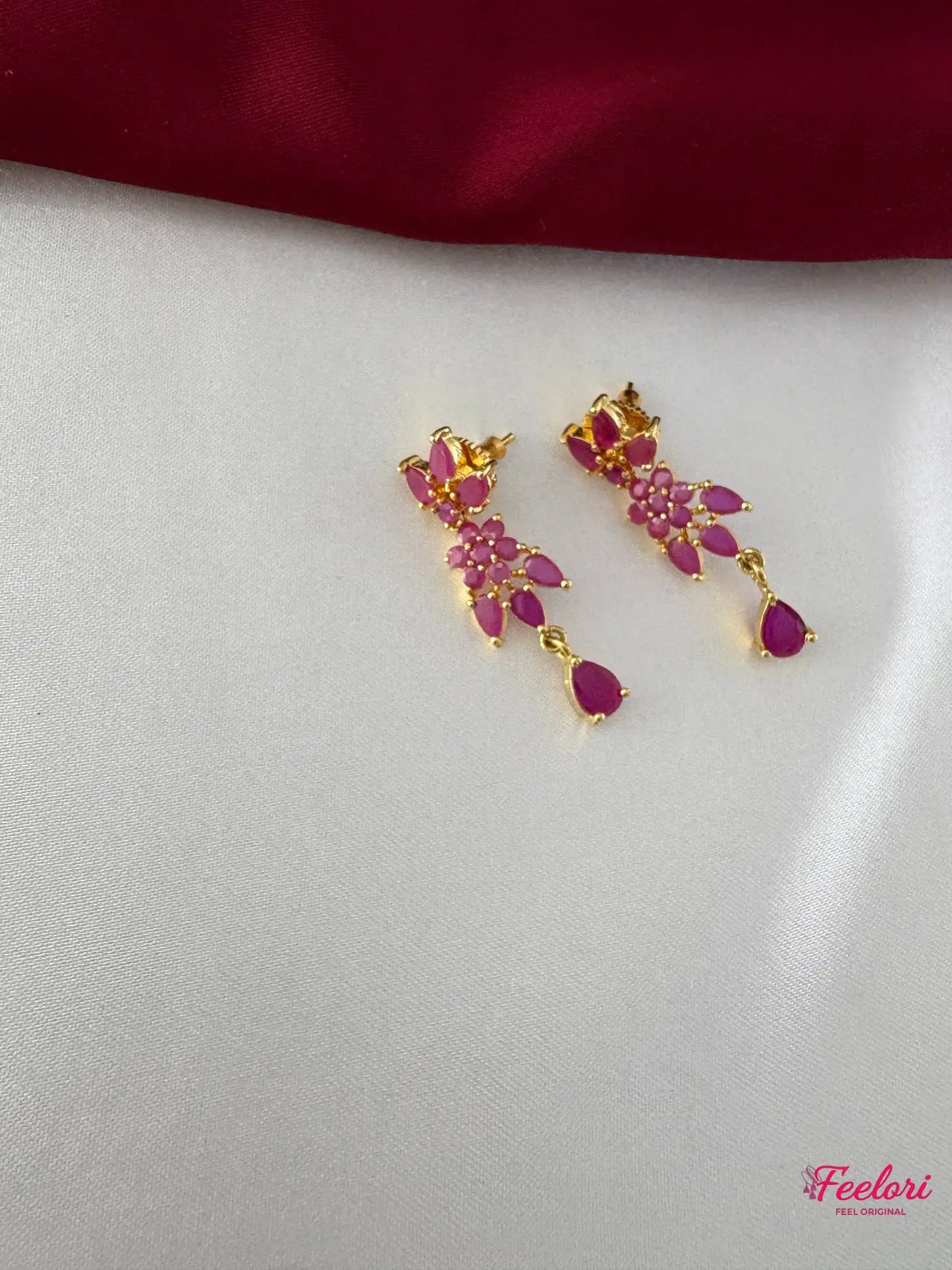 FeelOri Gold Plated Ruby Flower Earrings - Close-up view of the matching earrings featuring a cluster of ruby-hued stones and a delicate teardrop dangle.