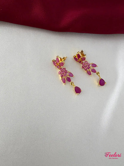 FeelOri Gold Plated Ruby Flower Earrings - Close-up view of the matching earrings featuring a cluster of ruby-hued stones and a delicate teardrop dangle.