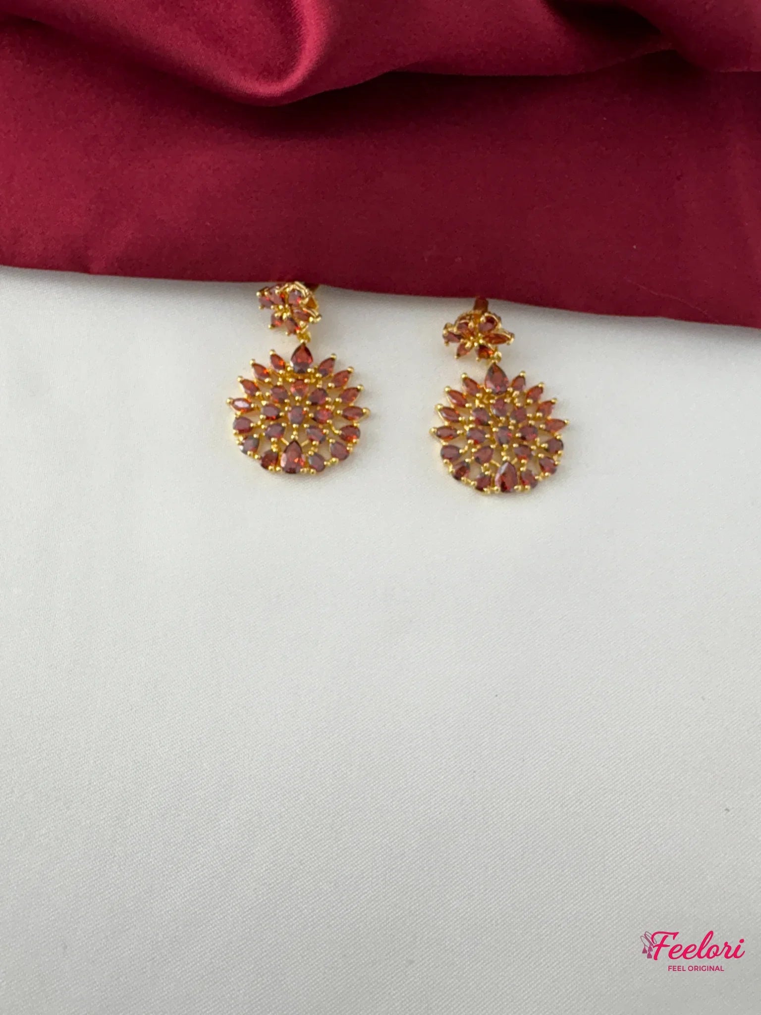 FeelOri Gold Plated Ruby Petal Cluster Earring - Detailed view of one earring with multiple Ruby-Tone CZ petals forming a starburst design.