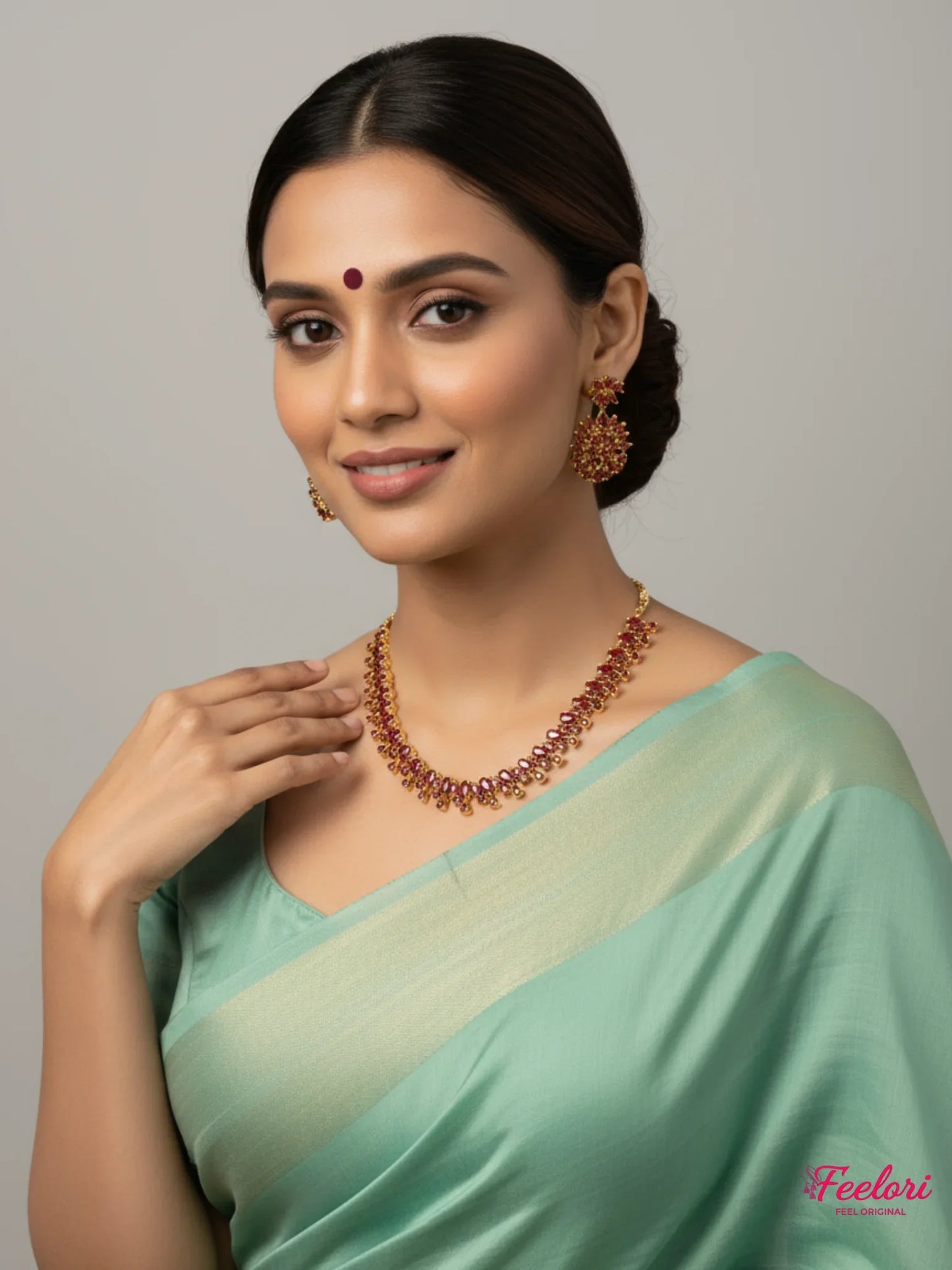 FeelOri Gold Plated Ruby Petal Cluster Necklace Set - Model in a green saree showcasing the radiant set.