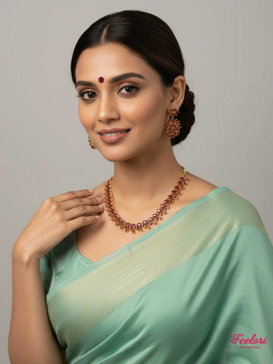 FeelOri Gold Plated Ruby Petal Cluster Necklace Set - Model in a green saree showcasing the radiant set.