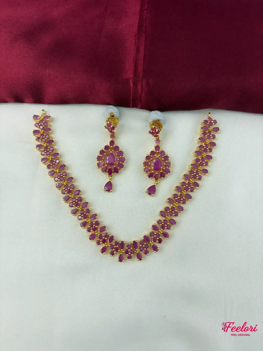 FeelOri Gold Plated Ruby Petal Necklace Set - Front view showcasing the complete necklace and matching earrings with intricate ruby settings.