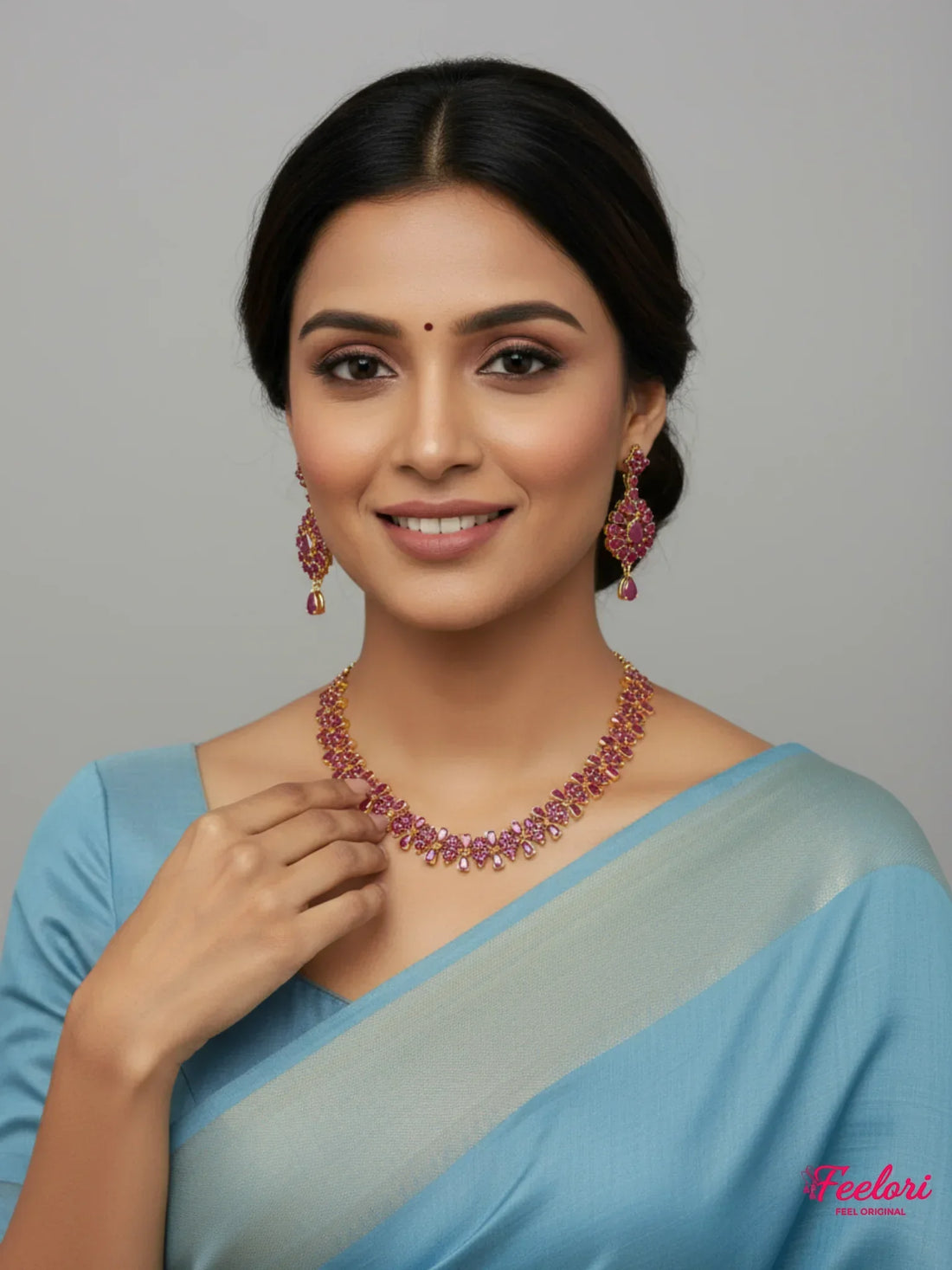 FeelOri Gold Plated Ruby Petal Necklace Set - Model wearing set with blue traditional saree, smiling confidently