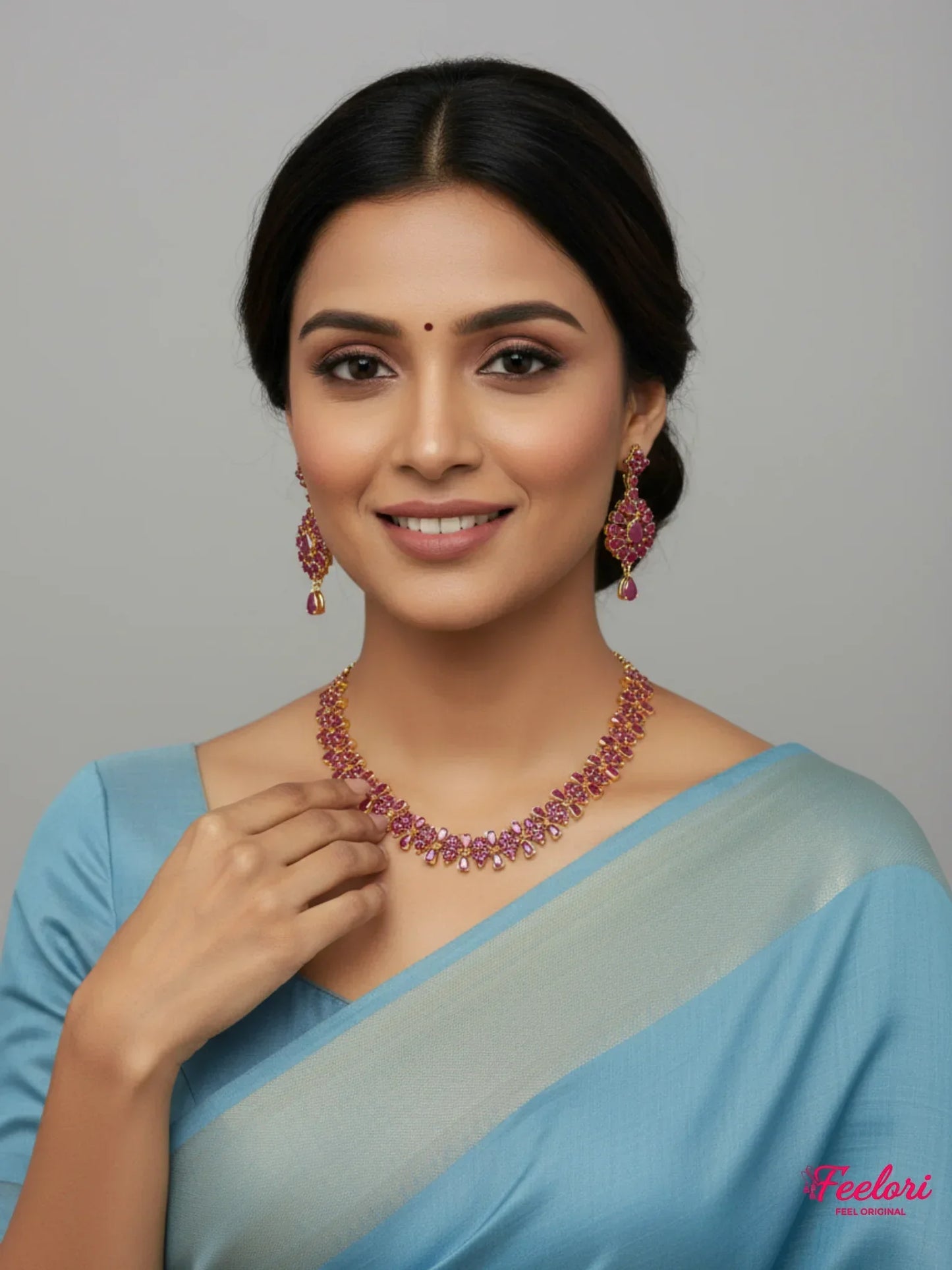 FeelOri Gold Plated Ruby Petal Necklace Set - Model wearing set with blue traditional saree, smiling confidently