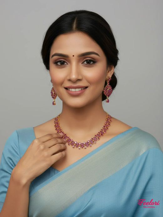 FeelOri Gold Plated Ruby Petal Necklace Set - Model wearing set with blue traditional saree, smiling confidently
