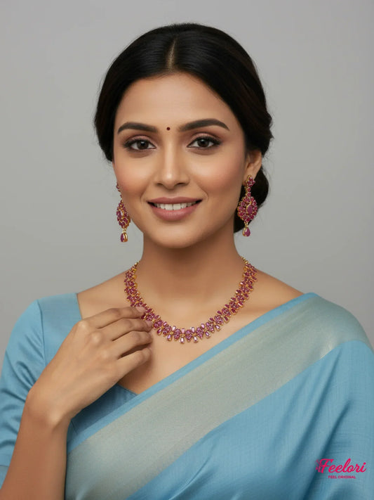 FeelOri Gold Plated Ruby Petal Necklace Set - Model wearing set with blue traditional saree, smiling confidently
