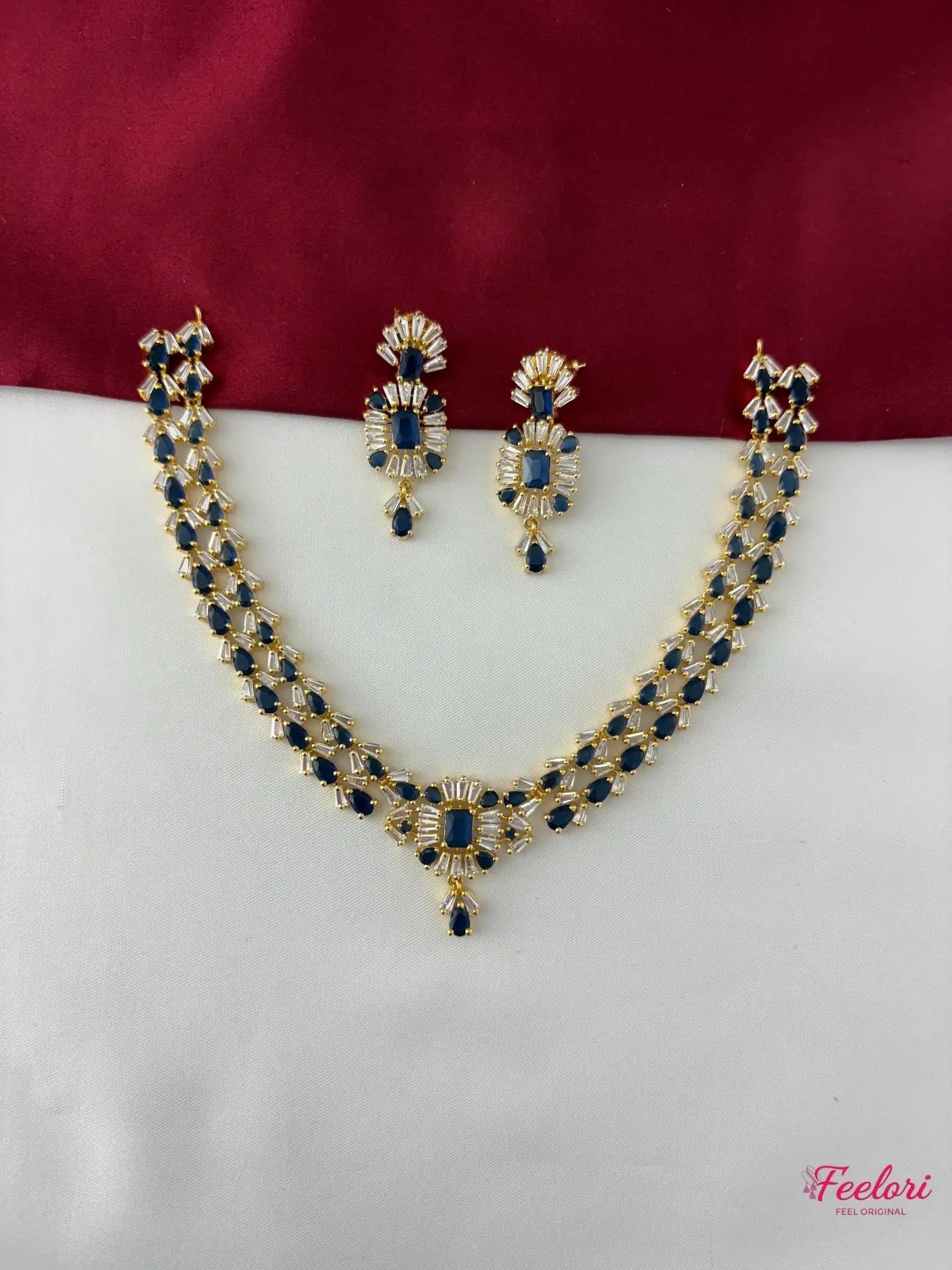 FeelOri Gold Plated Sapphire AD Necklace Set - Front view showcasing the complete set with geometric blue and white stones on a dual-toned background.