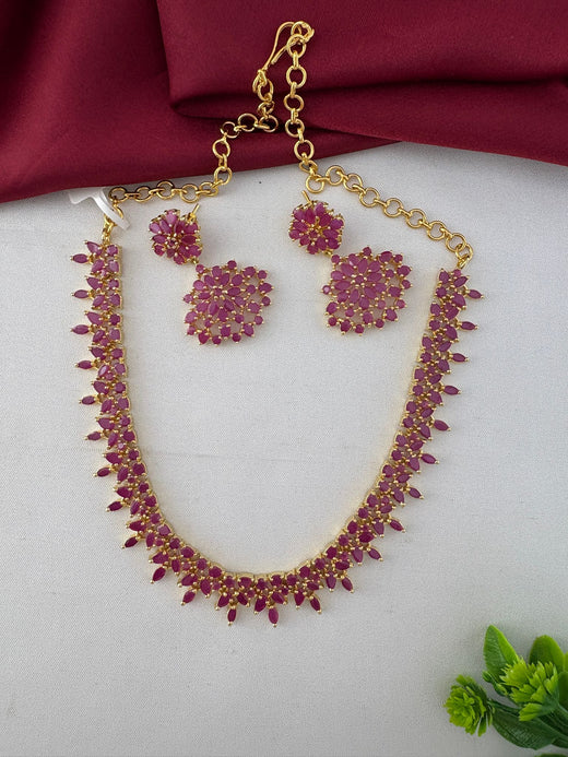 Full view of the Feelori Gorgeous Ruby-Tone CZ Short Necklace Set with earrings, displaying the chain and clasp detail, perfect for celebrations.