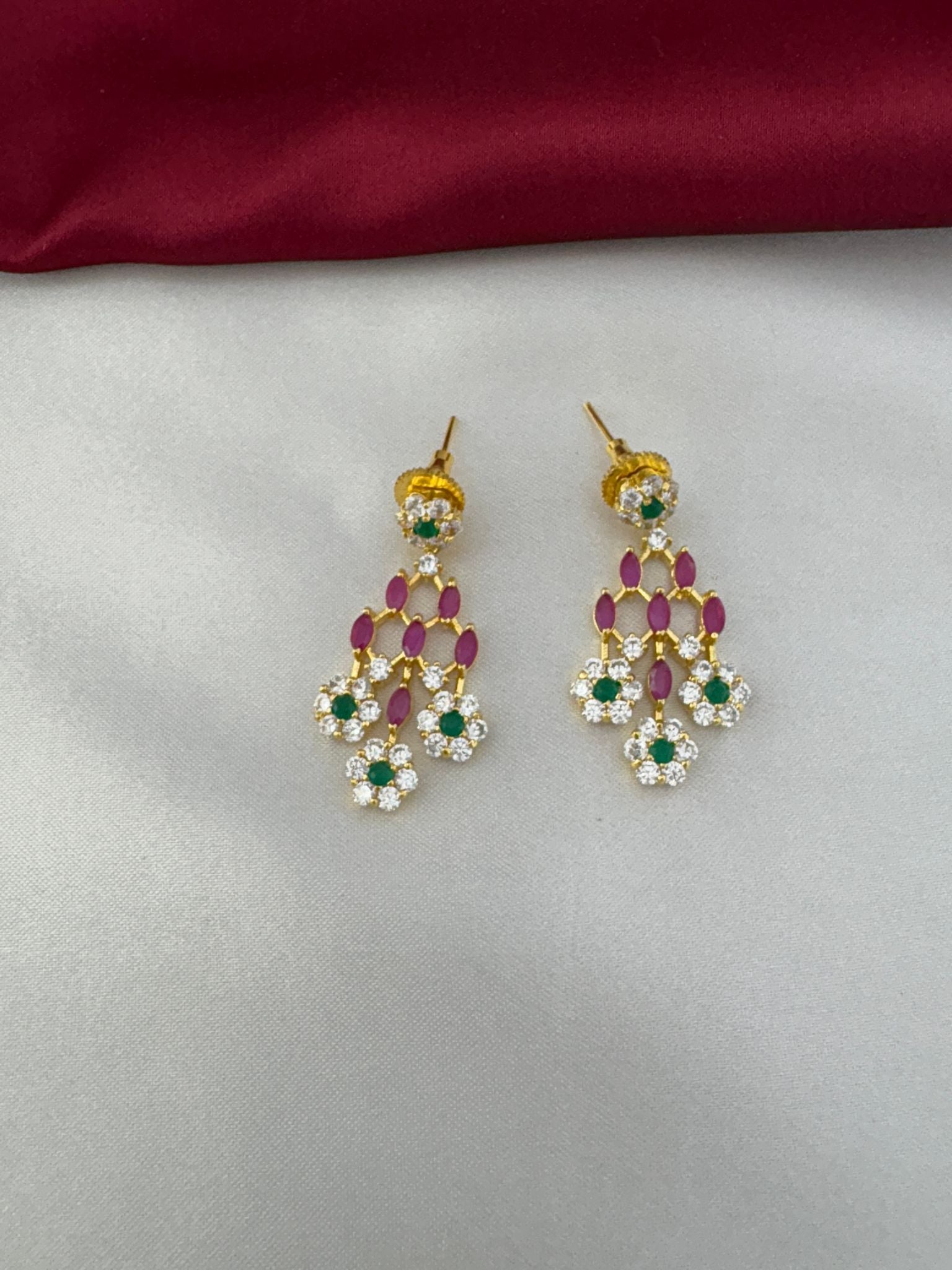 Close-up of the matching earrings from the FeelOri Jewel Tone Majesty Multi-Color AD Necklace Set, showing ruby, emerald, and clear stone details.