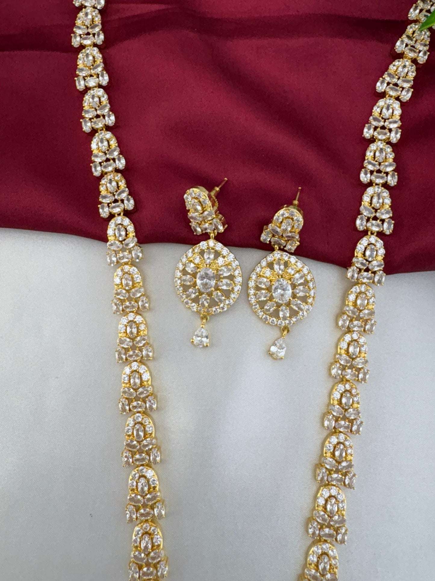 Detailed close-up of FeelOri Luminous Cascade White AD Necklace chain and earring design.