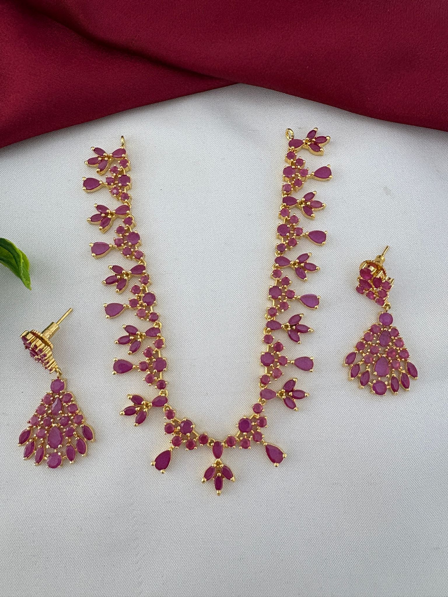 FeelOri Majestic Ruby-Tone CZ Short Necklace shown at full length with matching earrings. Kerala reception jewelry set by FeelOri.