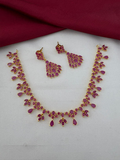 FeelOri Majestic Original Ruby Short Necklace Set with earrings laid flat. Gold-plated ruby stone jewelry for Kerala receptions by FeelOri.