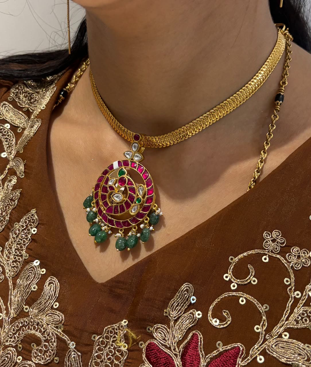 FeelOri Mayur Pathakam Peacock Pendant styled on a chain with a brown embroidered outfit; pendant only, SKU FO-RKJ-0164.