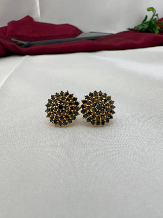 FeelOri Midnight Glam black AD stud earrings pair displayed on white fabric background showing cluster gemstone design