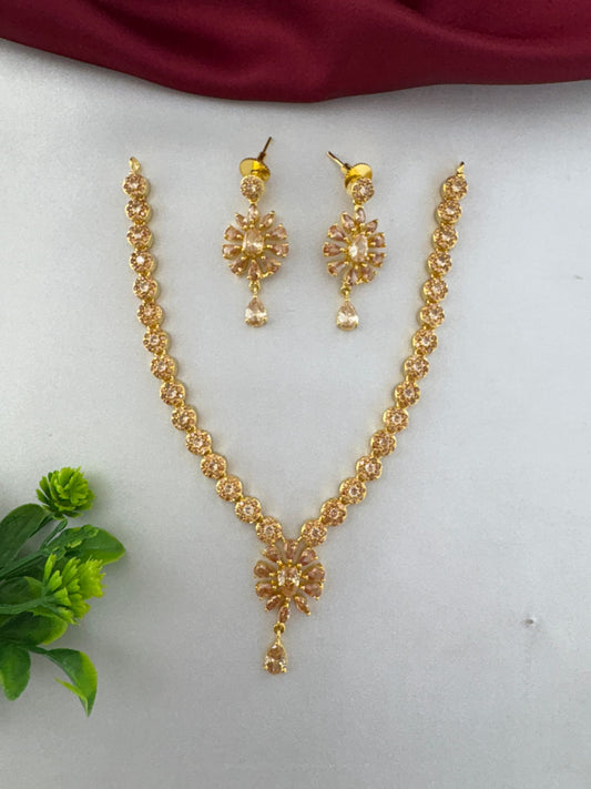 Full view of the FeelOri Modern Aura Gold AD Geometric Short Pendant Set, showcasing the necklace and matching earrings with intricate floral stone design.