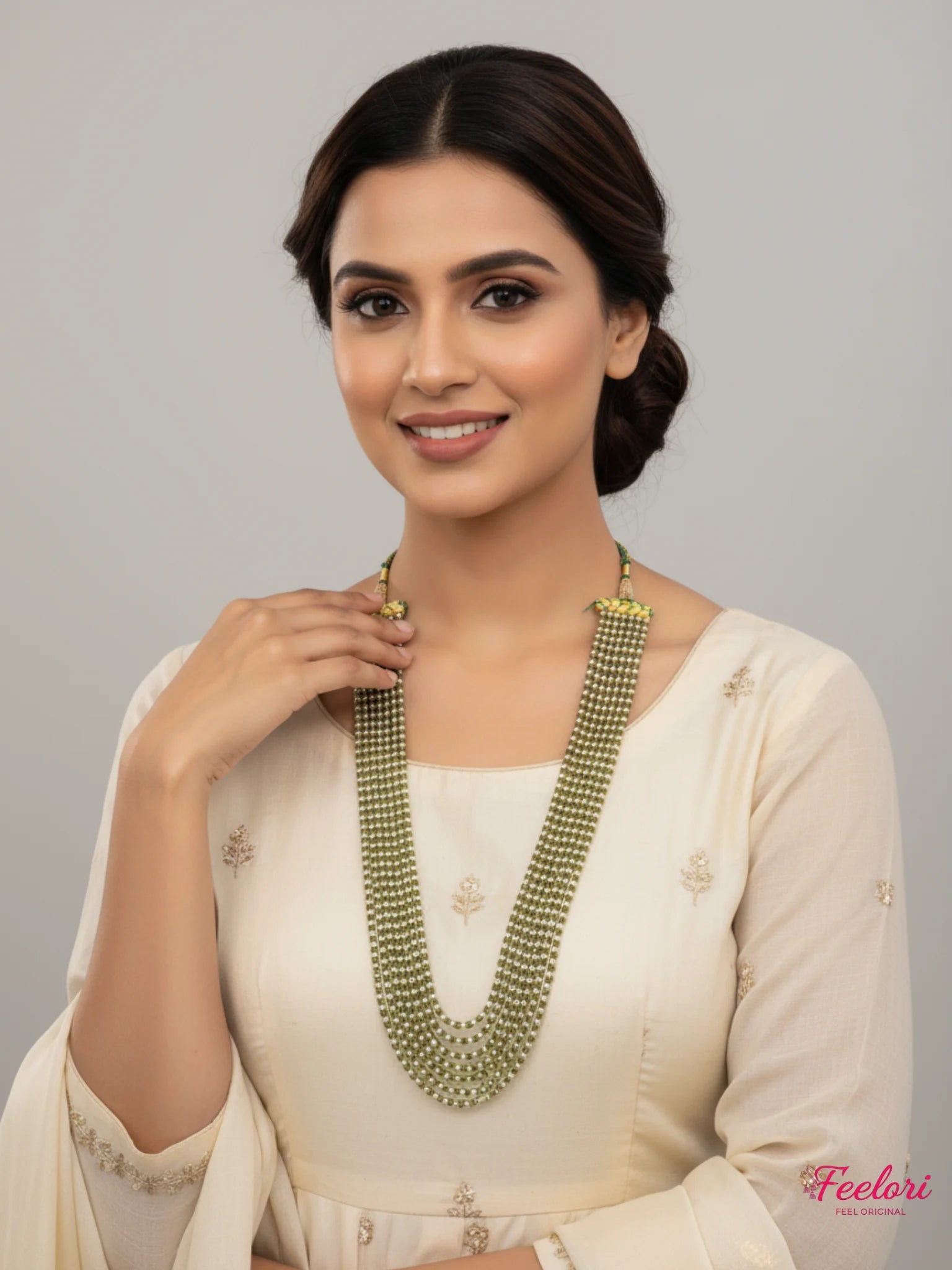 FeelOri Gold Plated Mala Necklace - Elegant model wearing multi-strand pearl necklace with cream attire