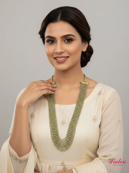FeelOri Gold Plated Mala Necklace - Elegant model wearing multi-strand pearl necklace with cream attire