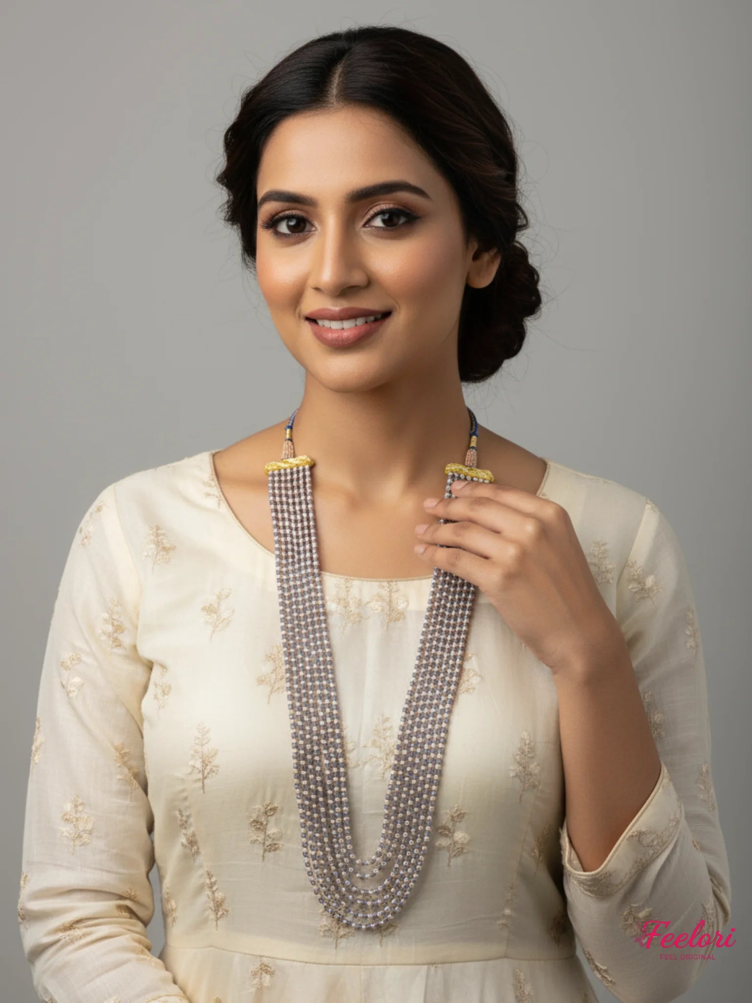 FeelOri Gold Plated Necklace - Model wearing Mother of Pearl Multi-Strand Beads Mala with CZ tassels elegantly.