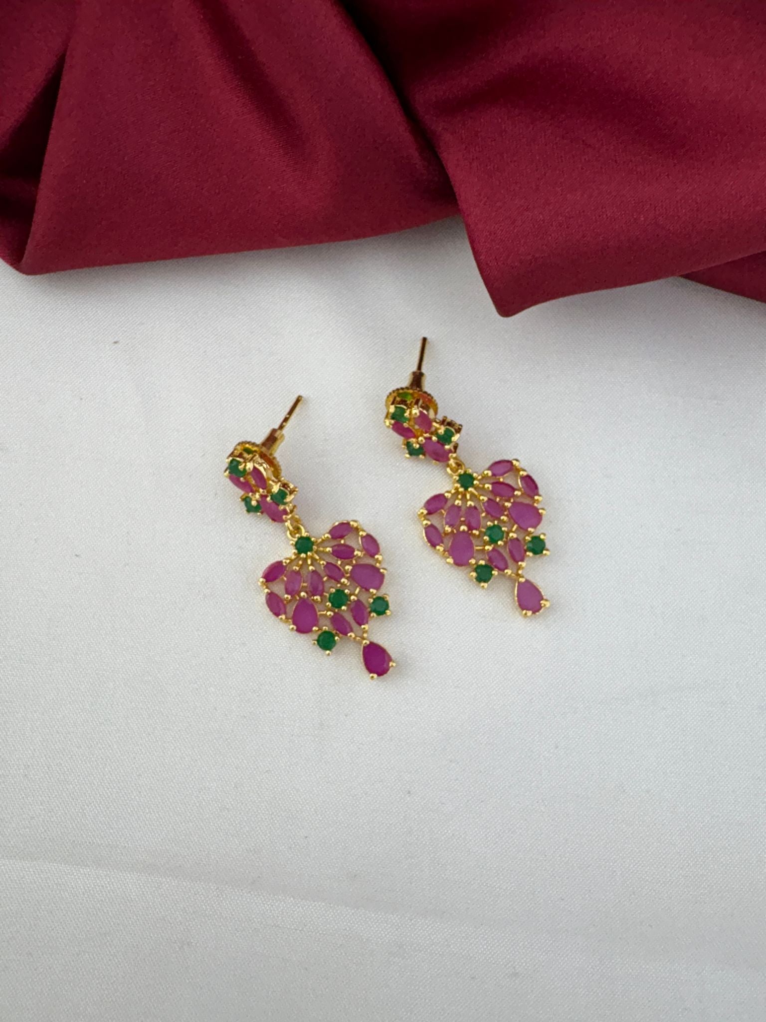 Detailed close-up of the FeelOri Mysore Vasantham ruby and emerald stone earrings, highlighting the design.