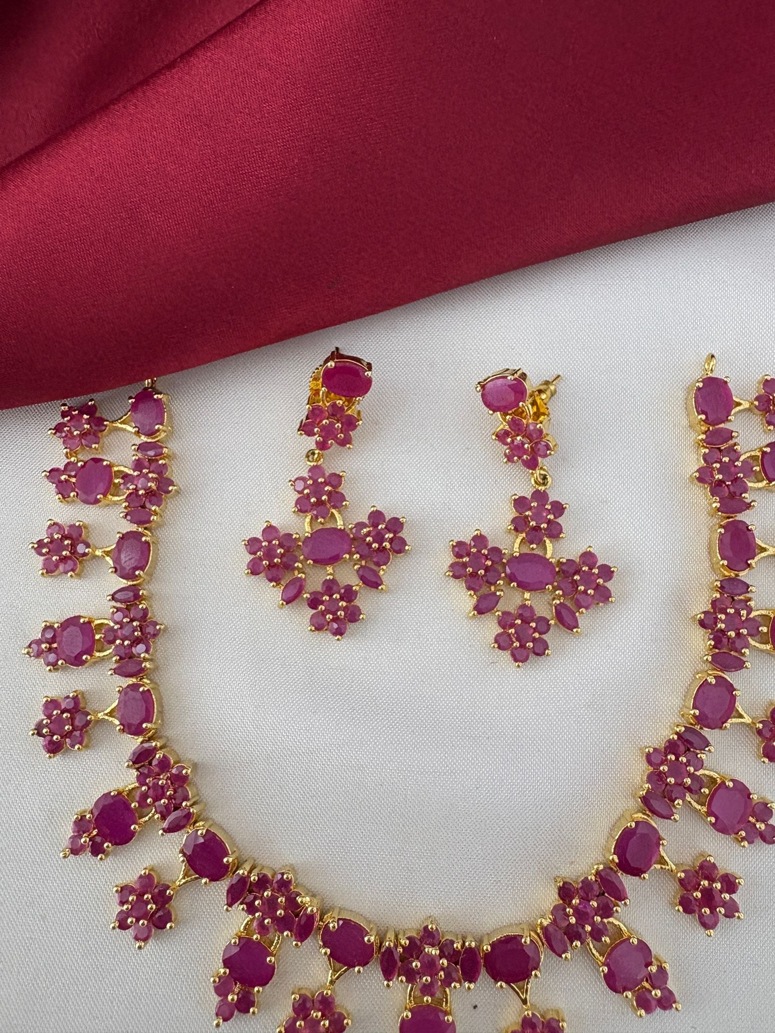 Detailed close-up of FeelOri Nakshi Work Ruby earrings and necklace. Highlights the intricate design and gemstones of the Telangana Art inspired set by feelori.