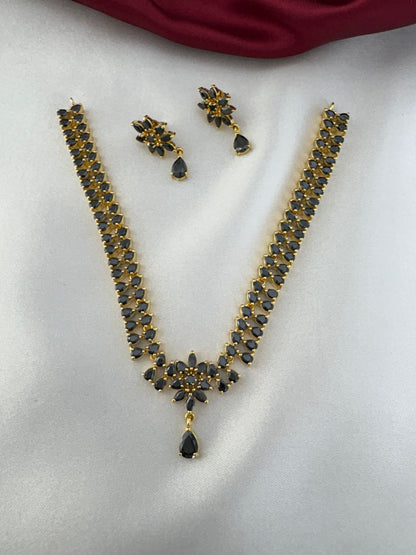 Main view of FeelOri Noir Elegance Black AD Solitaire Short Pendant Set with matching earrings, featuring black stones and gold-tone finish.