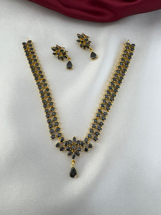 Main view of FeelOri Noir Elegance Black AD Solitaire Short Pendant Set with matching earrings, featuring black stones and gold-tone finish.