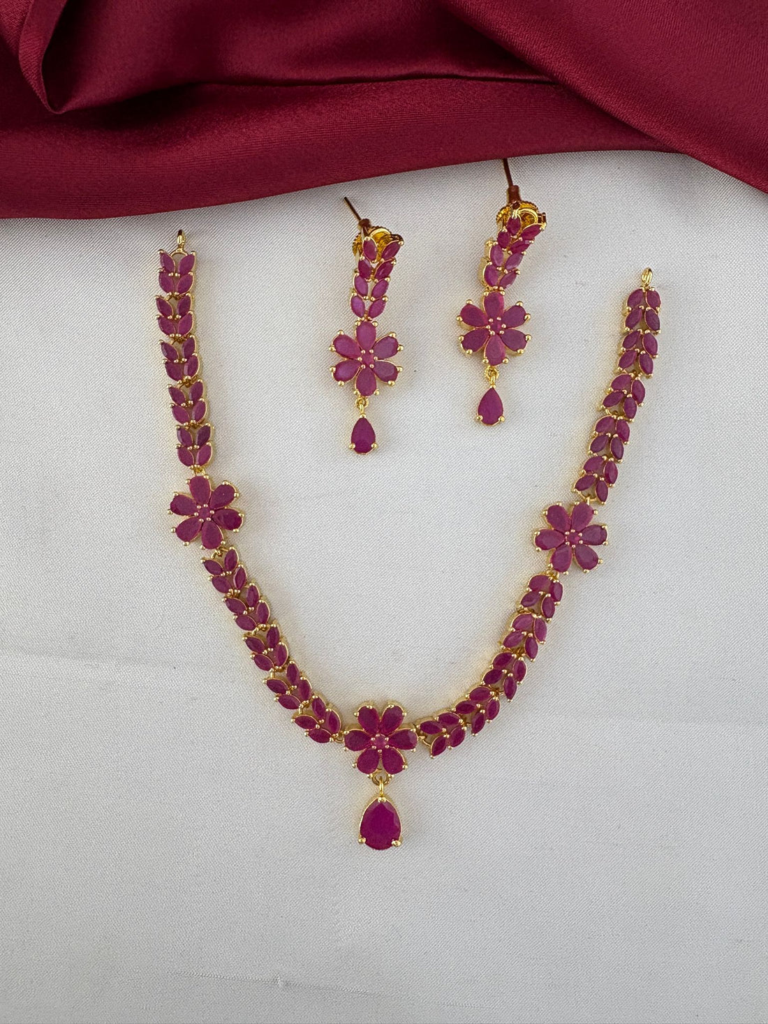 FeelOri Opulent Ruby-Tone CZ Short Necklace and Earrings Set flat lay view, perfect for grand weddings.