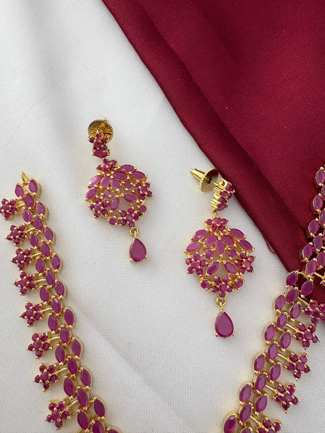 Detailed view of the FeelOri Temple Design on the Ruby-Tone CZ Short Necklace and Earrings, showing authentic craftsmanship by feelori.
