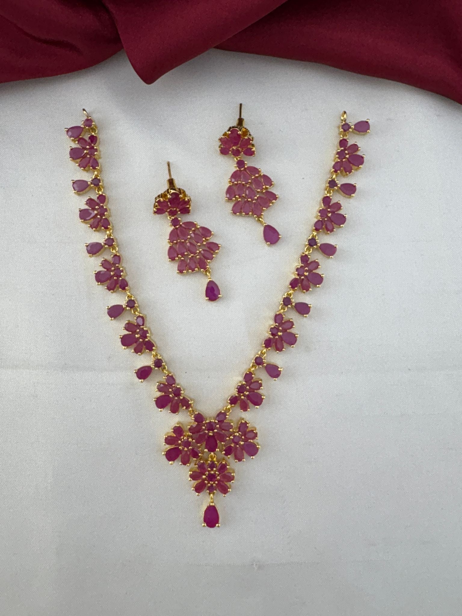 FeelOri Party Wear Ruby-Tone CZ Short Necklace Set - Main view of the necklace and matching earrings.