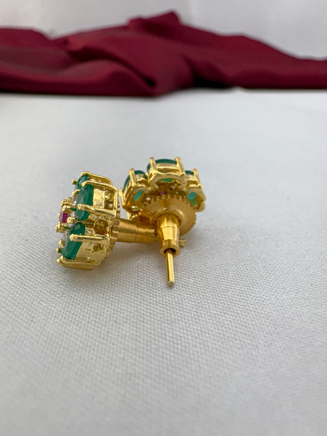 FeelOri Peridot Gleam olive green AD stud earrings angled view displaying gold post construction and back mechanism