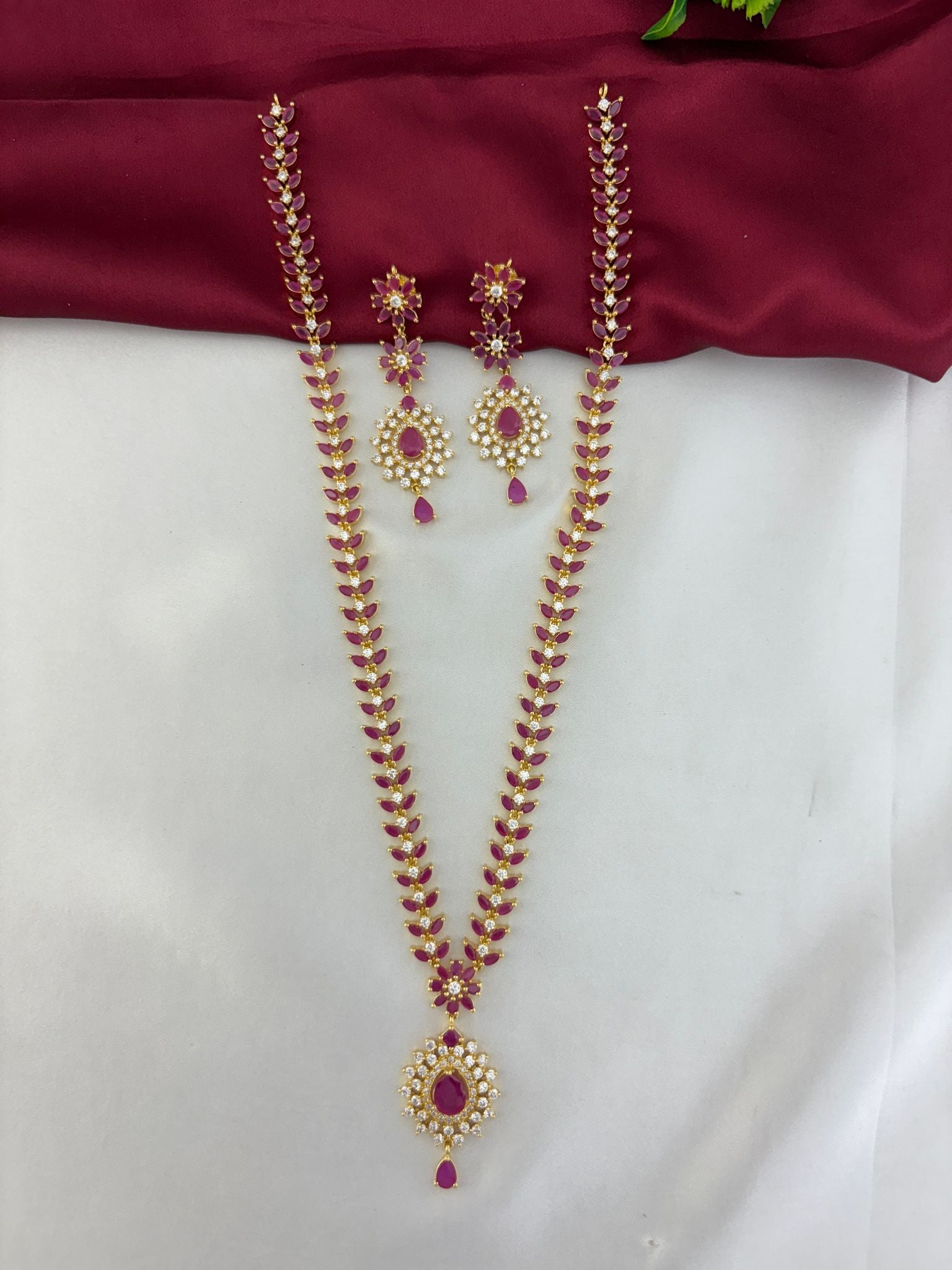 Overhead display of the FeelOri Regal Ruby Bloom AD Cluster Long Necklace and Earring Set.