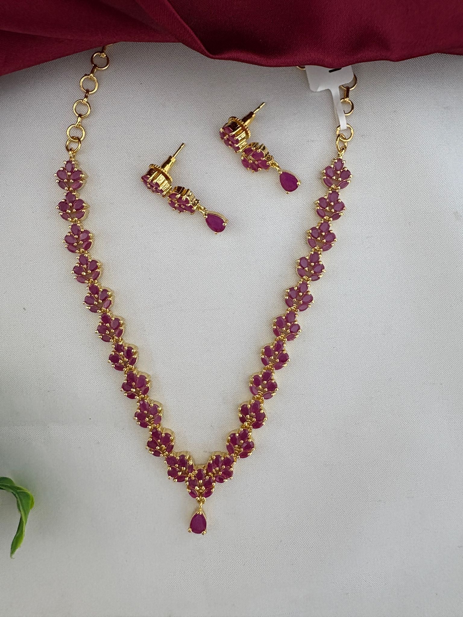Angled view of FeelOri Regal Original Ruby Pendant Short Necklace and Earrings Set for Chennai weddings.
