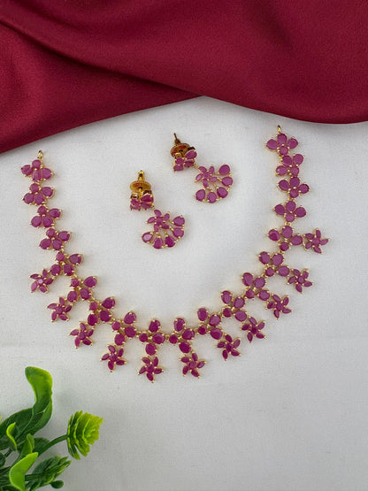 FeelOri Exclusive Original Ruby Short Necklace Set - Designer Wear - Styled view with earrings and decorative leaf.