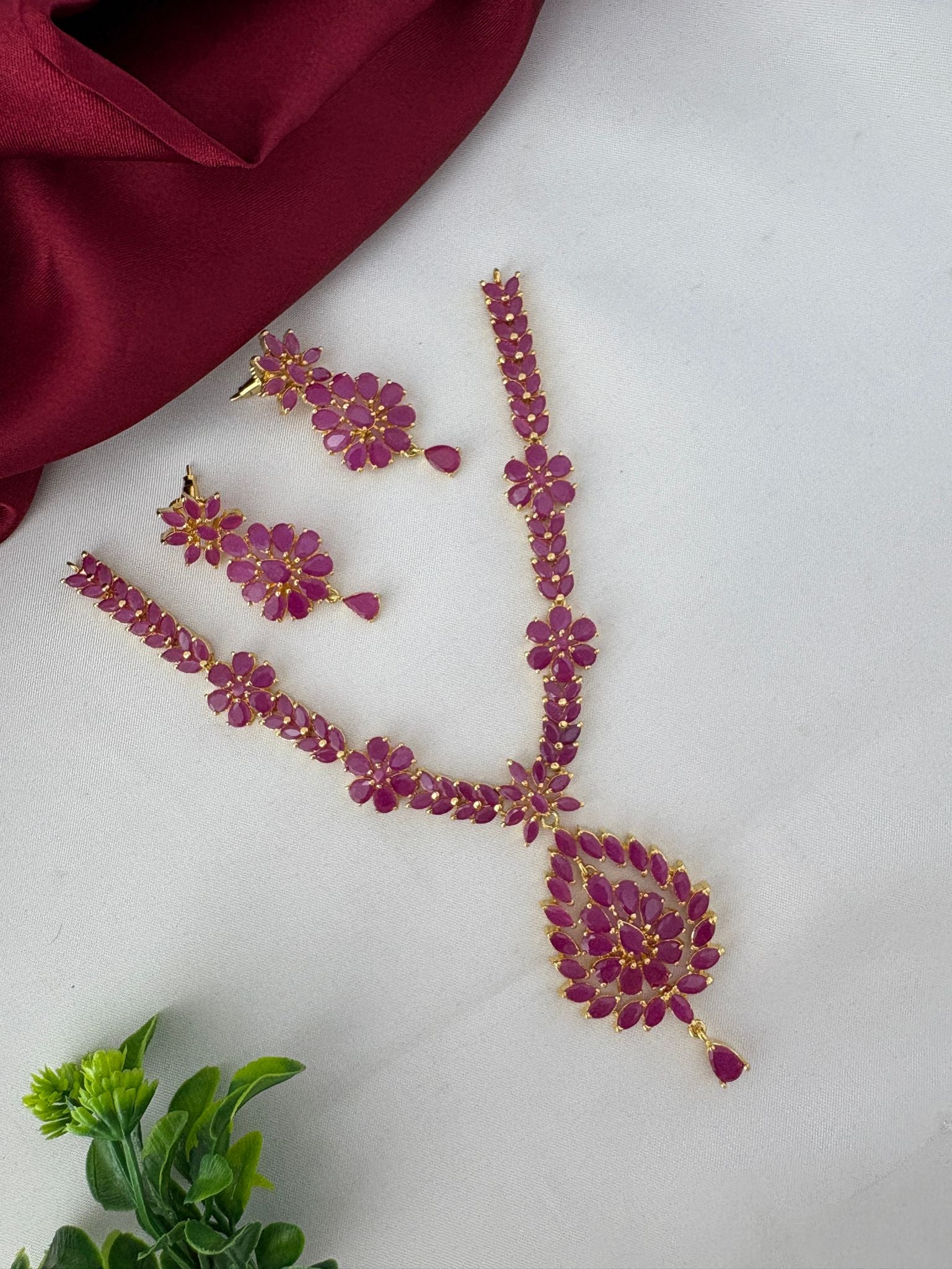 FeelOri Traditional Ruby-Tone CZ Short Necklace Set displayed at an angle to highlight its ethnic charm and design.