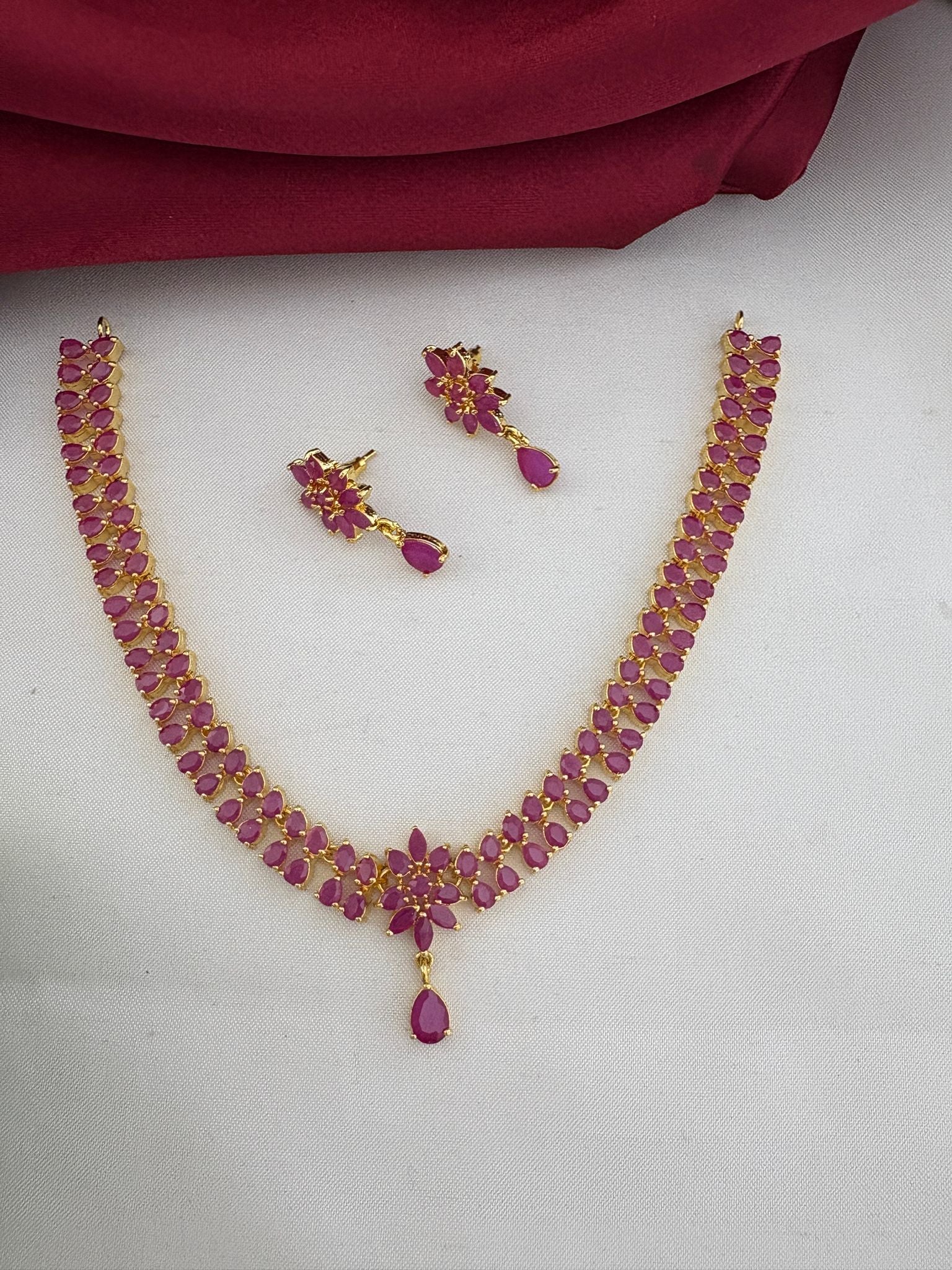 FeelOri Luxury Ruby-Tone CZ Short Necklace Set - Premium South Indian Design. Necklace shown with earrings placed separately for detail.