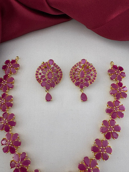 Detailed close-up of the earrings and floral ruby stone links from the FeelOri Charming Ruby-Tone CZ Short Necklace Set.