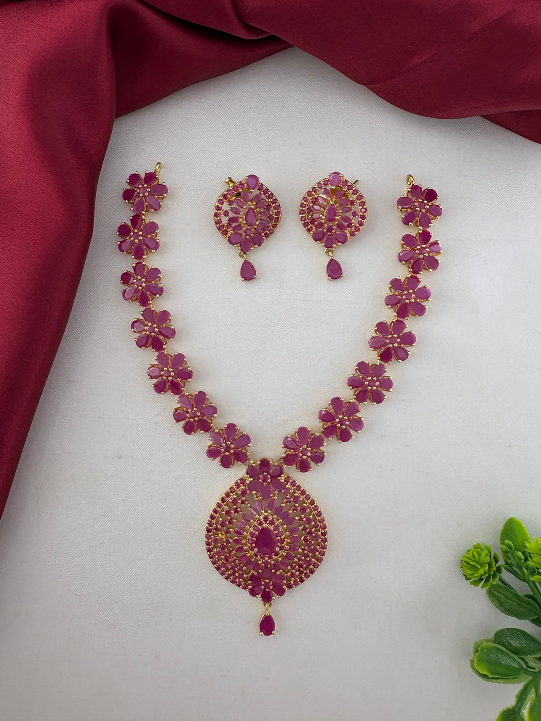 FeelOri Charming Ruby-Tone CZ Short Necklace Set for Telugu Weddings, including necklace and earrings, displayed on a white and maroon background.