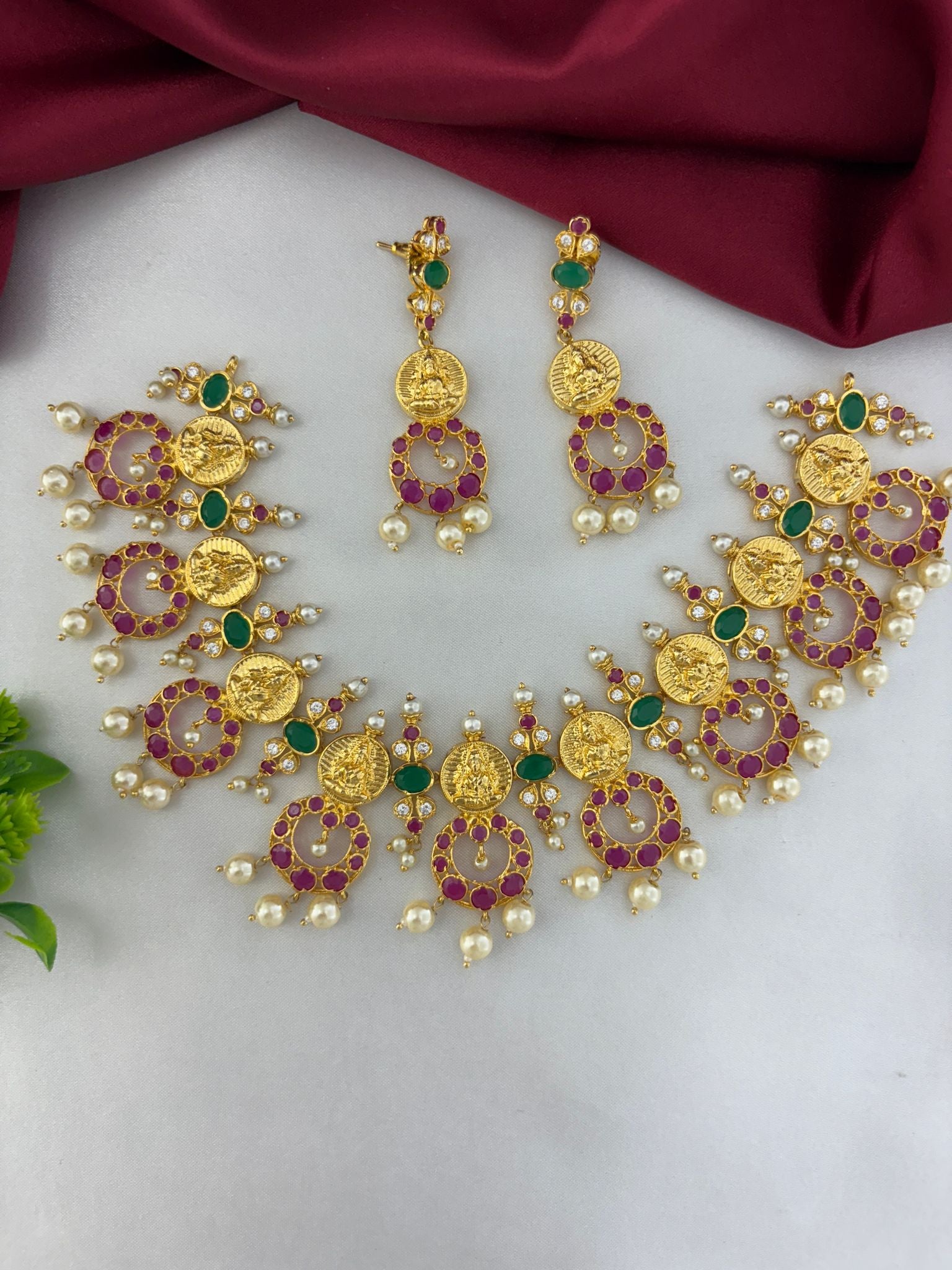 FeelOri Sunset Hues Multi-Color AD Short Pendant Set with matching earrings. Gold-plated necklace set with red, green, and white AD stones and pearl drops by feelori.