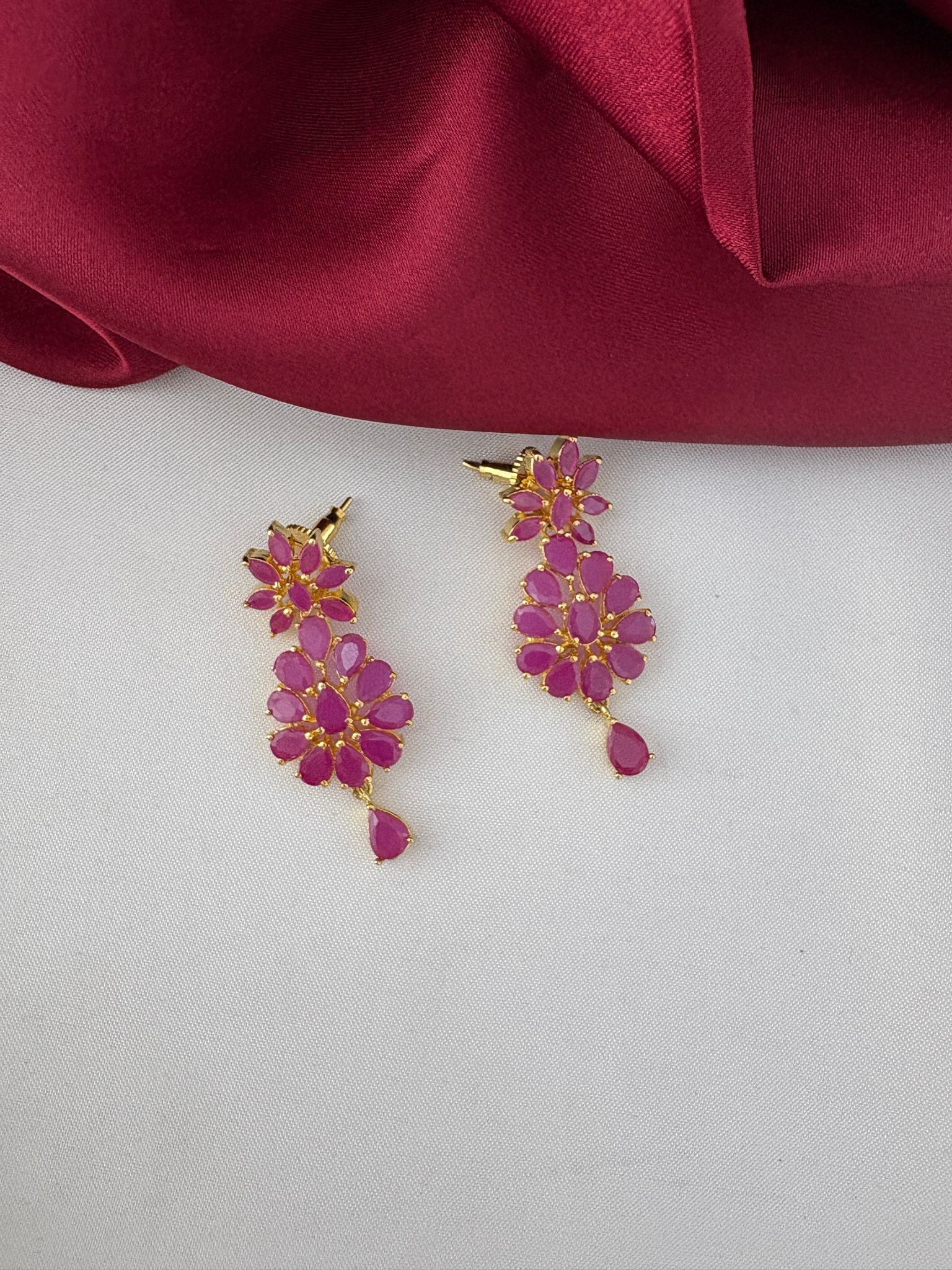 Close-up of FeelOri Traditional Ruby-Tone CZ Earrings featuring intricate ethnic design, part of the short necklace set.