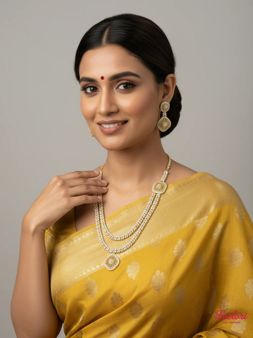 FeelOri gold-plated AD/CZ layered square motif necklace set styled with a yellow saree