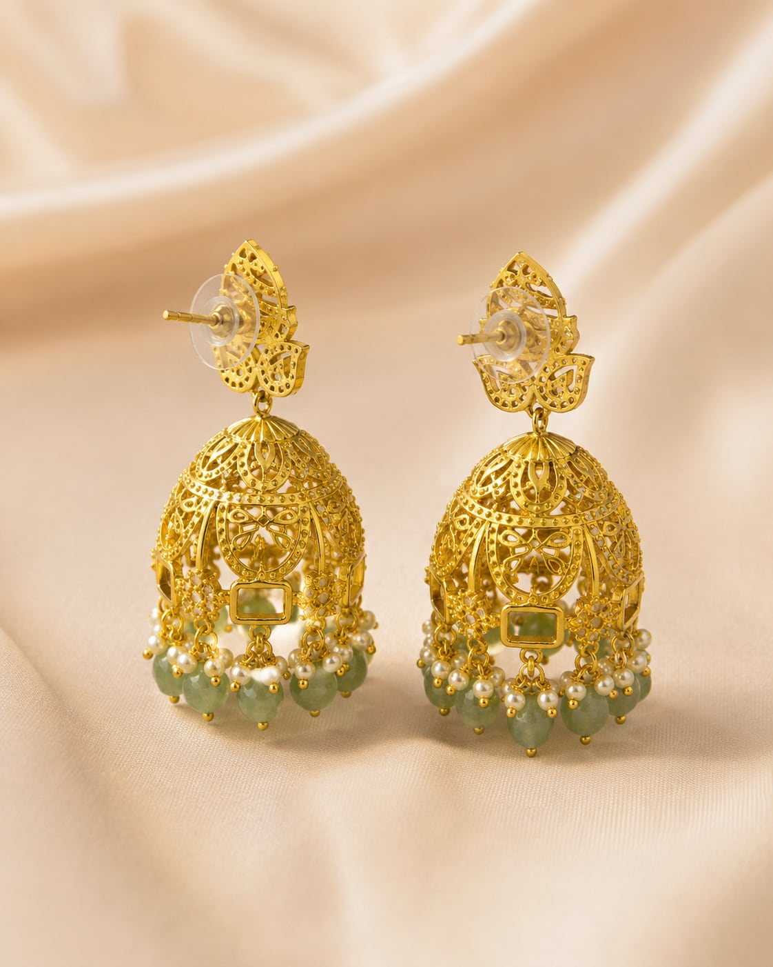 Rear view of FeelOri gold-plated emerald-drop CZ leaf jhumka earrings showing push-back closures