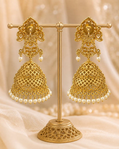 Rear view of FeelOri grand gold-plated emerald CZ jhumka earrings with pearl-look fringe showing push-back closures