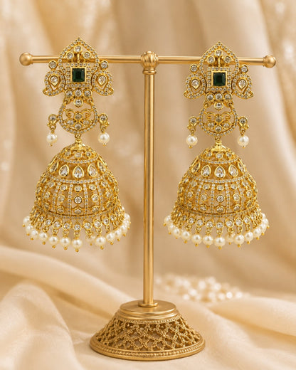 FeelOri grand gold-plated emerald CZ jhumka earrings with pearl-look fringe displayed as a matching pair