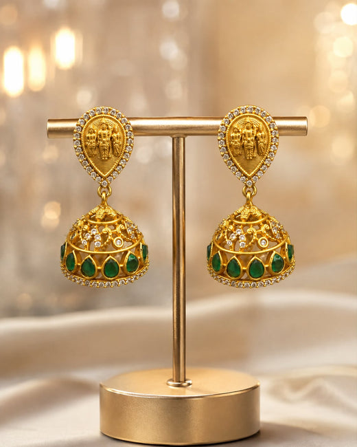 FeelOri gold-plated emerald jhumka earrings on jewellery display